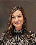 headshot of Young smiling with brown background