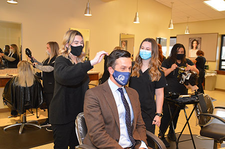 Chipola Cosmetology students Alyson James and Elise Armstrong discuss their program with Chancellor Henry Mack during his recent visit to Chipola. 