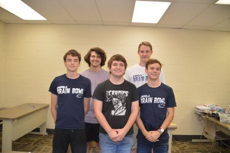 Five members of the Chipola Brain Bowl team poses for a group photo in a classroom.