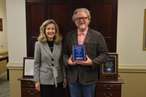 President Sarah Clemmons on left and Admin Employee of the Month Kurt McInnis on right