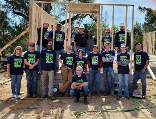 Students of Workforce Building Construction Technology pose to show their on site build for Habitat for Humanity