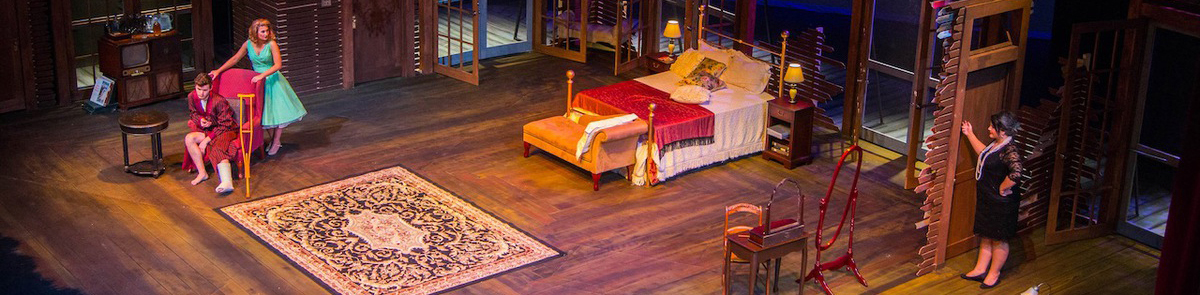 Three actors on stage during a Chipola  production of Cat on a Hot Tin Roof.