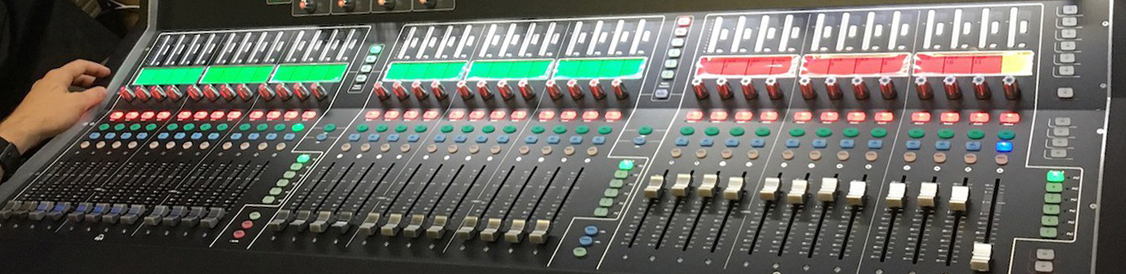 A person's hand rests on a control panel at the Chipola Center for Arts.