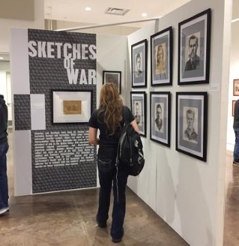 Student looking at art installation in art gallery.