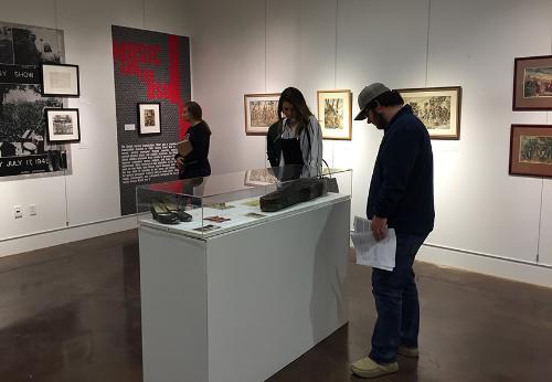 Student looking at art installation in art gallery.