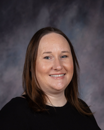 Take Stock in Children Coordinator's head shot smiling in front of grey background